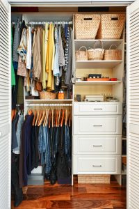 Clothes hung neatly in closet