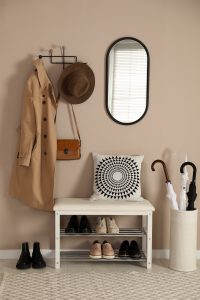 Organized entryway with shoes, coat, umbrellas